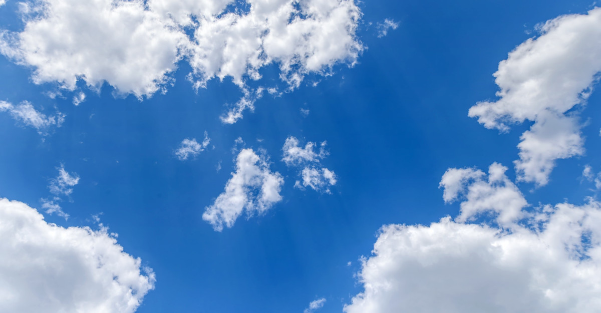 Beautiful blue sky with white clouds. Horizontal background or texture.
